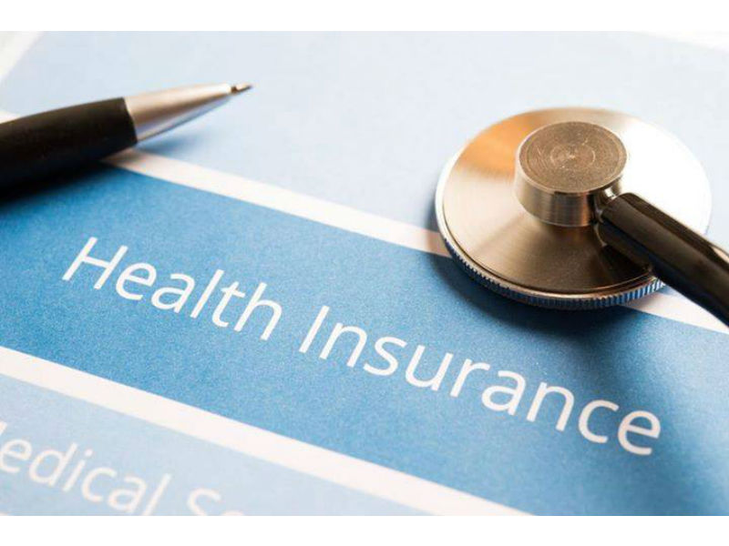 Health insurance with pen and stethascope