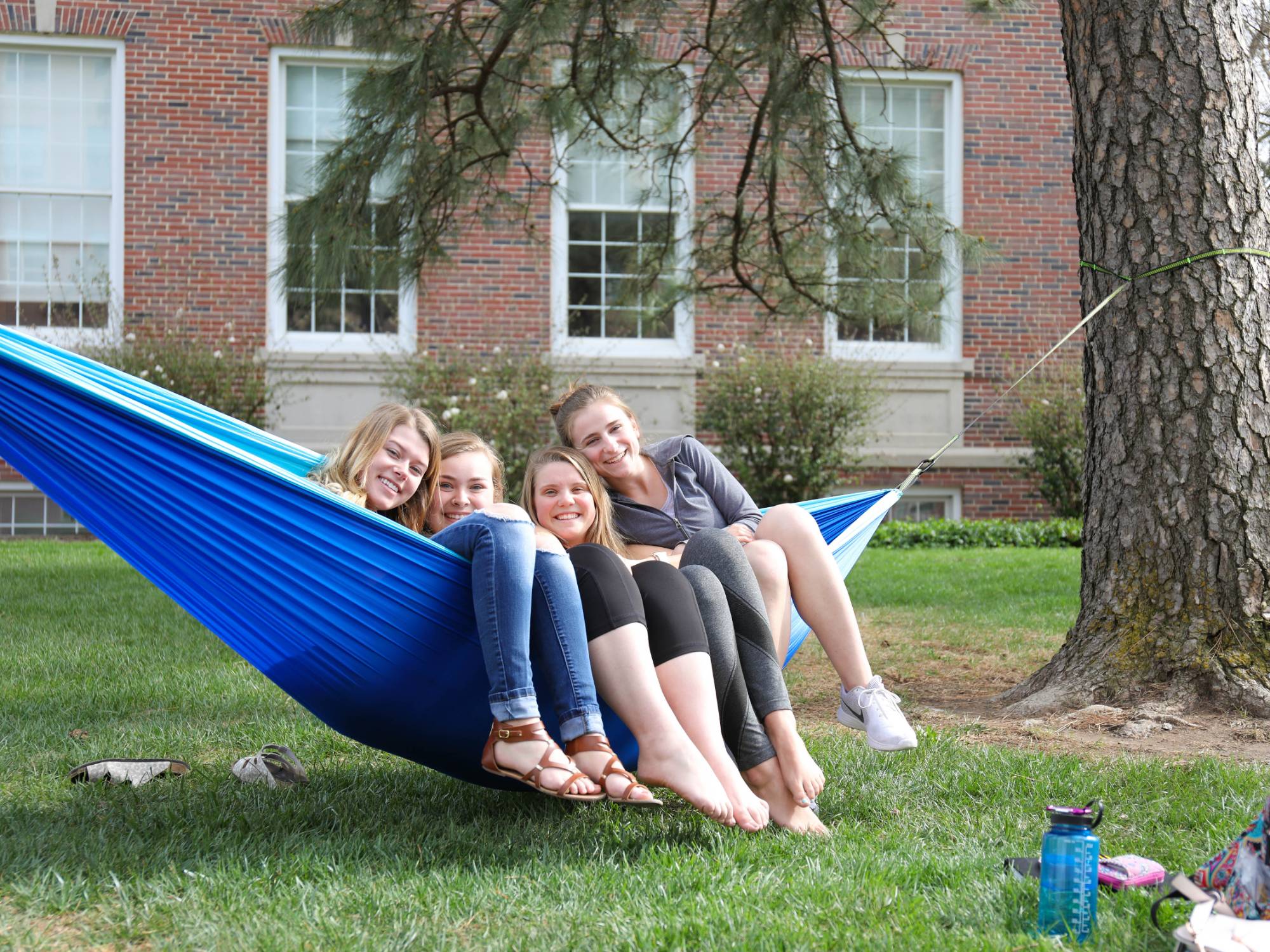 Girls hanging in hammock.