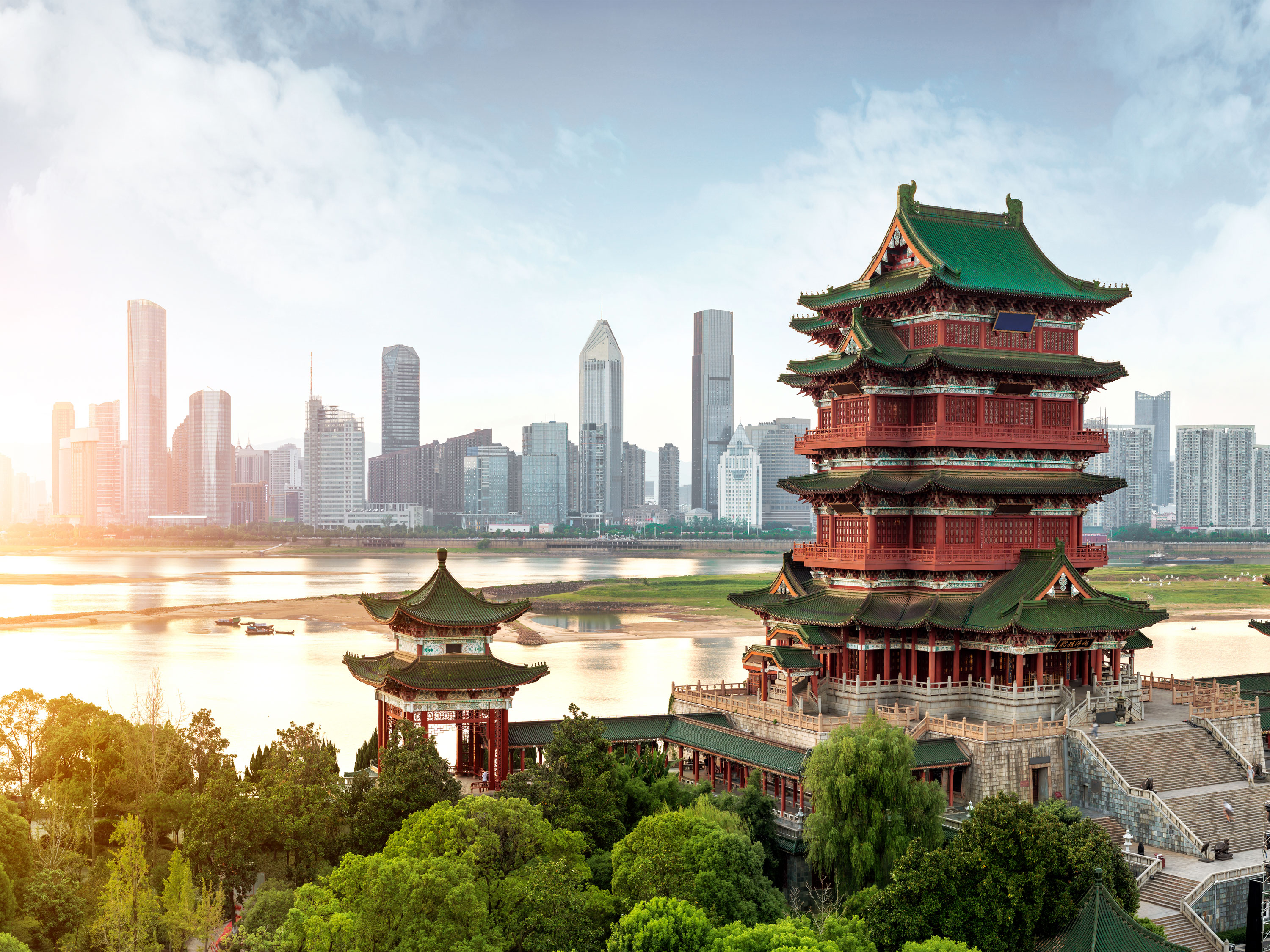 Classical Chinese architecture appears in the foreground, with skyscrapers in the background