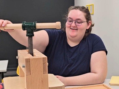 Lily operates the Book Beetle press Lily operates the Book Beetle press