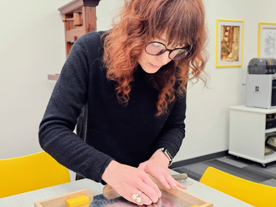 Liz adjusts magnetic furniture in a galley Liz adjusts magnetic furniture in a galley