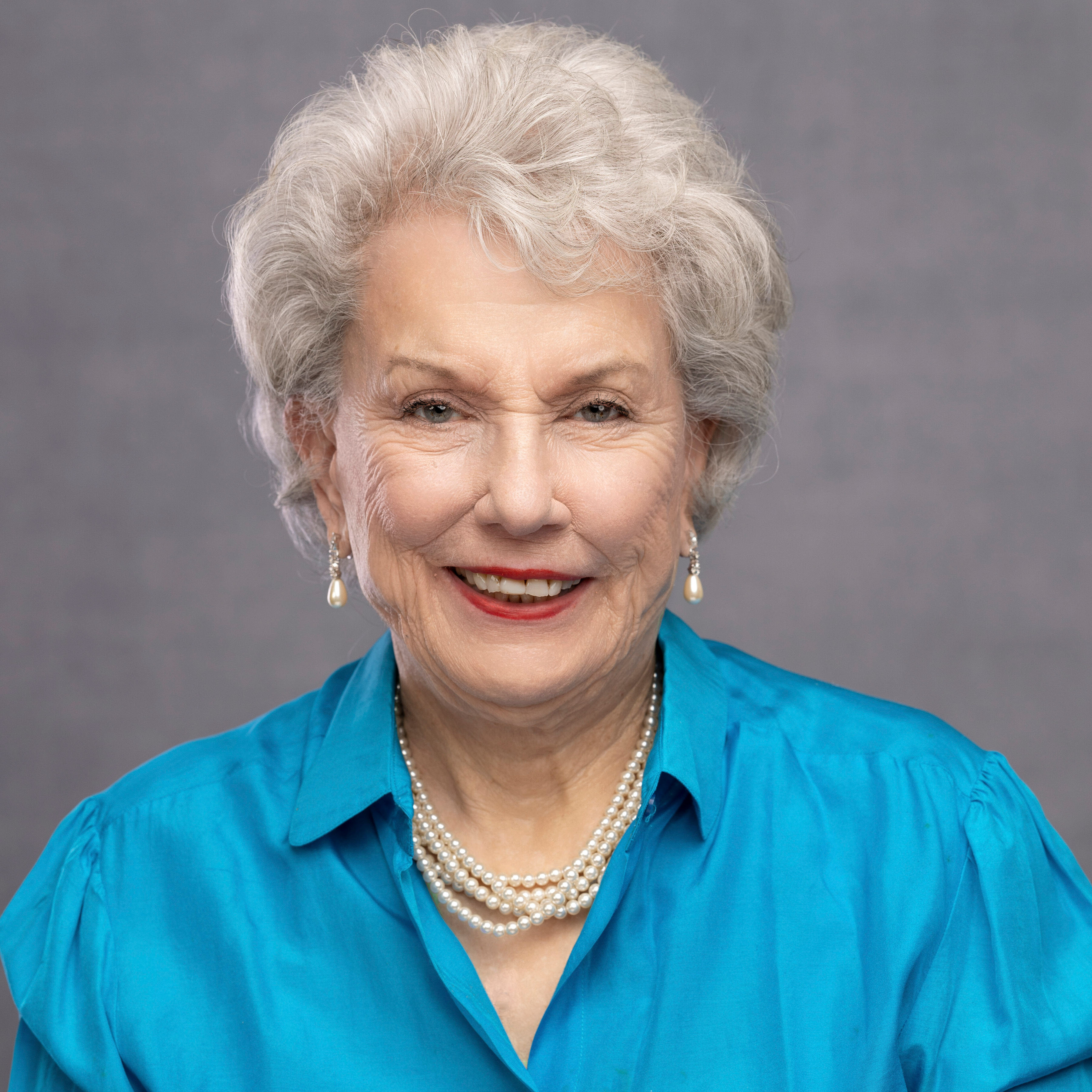 A portrait of Mary Sue Foster. She is wearing a light blue blouse.