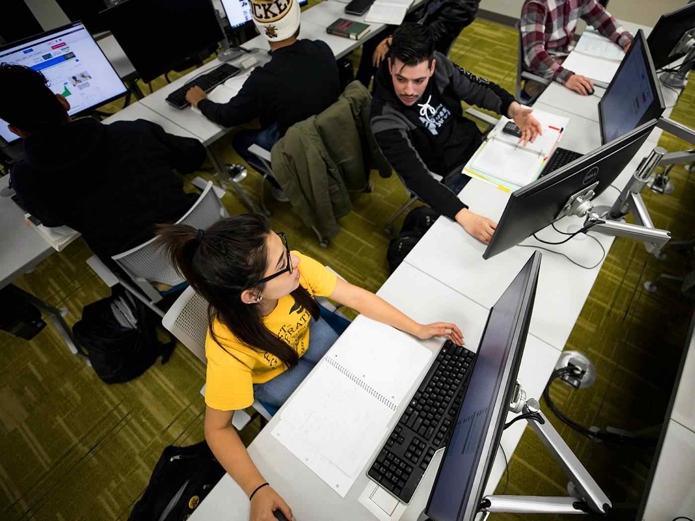 Students working in a business computer lab classroom