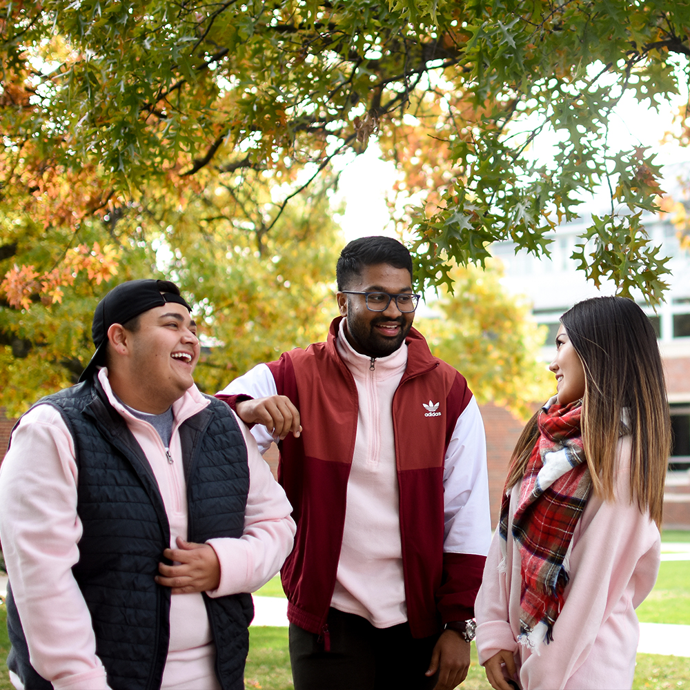 Students laughing with each other on campus.