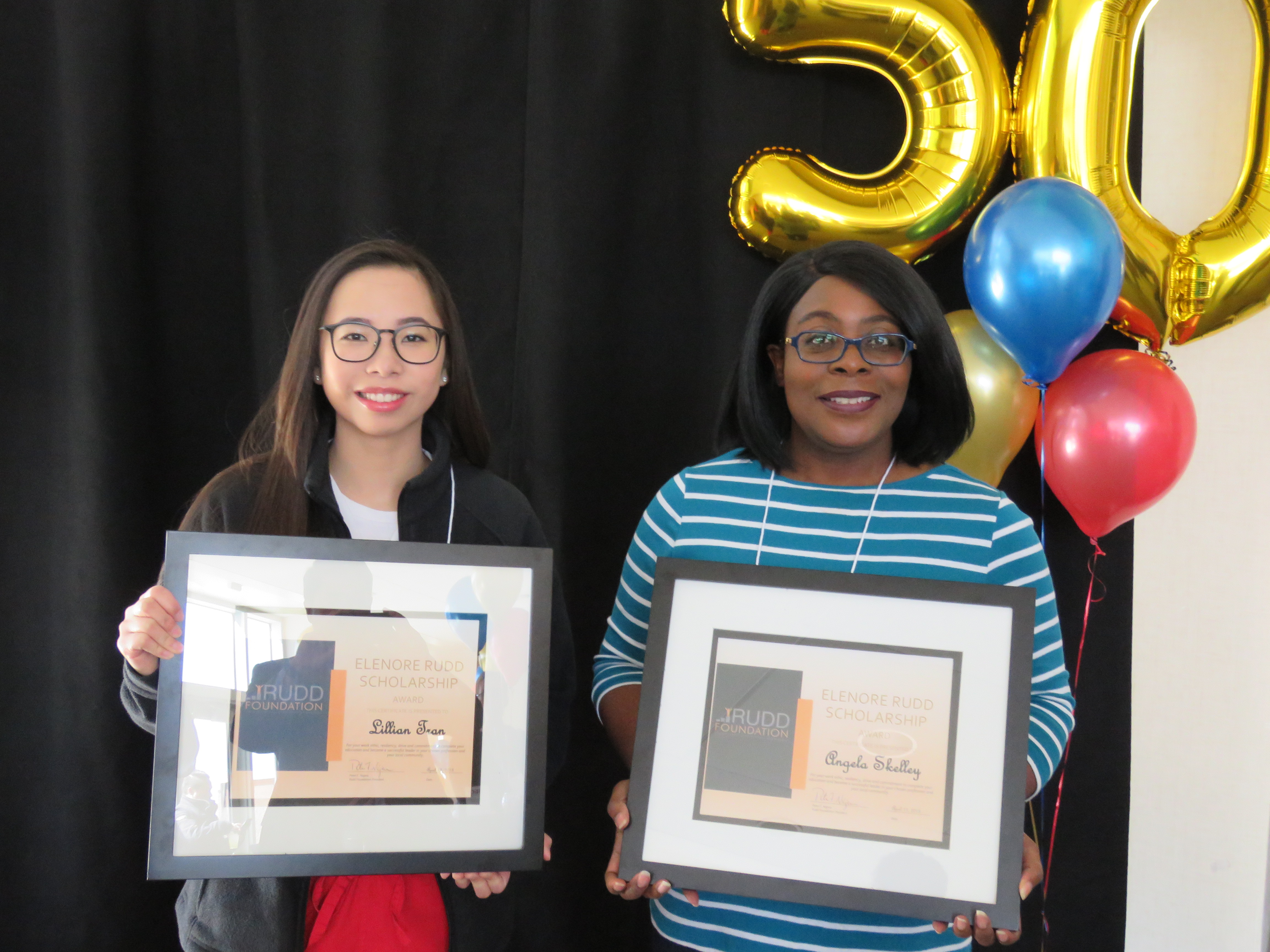 Two students display scholarship awards
