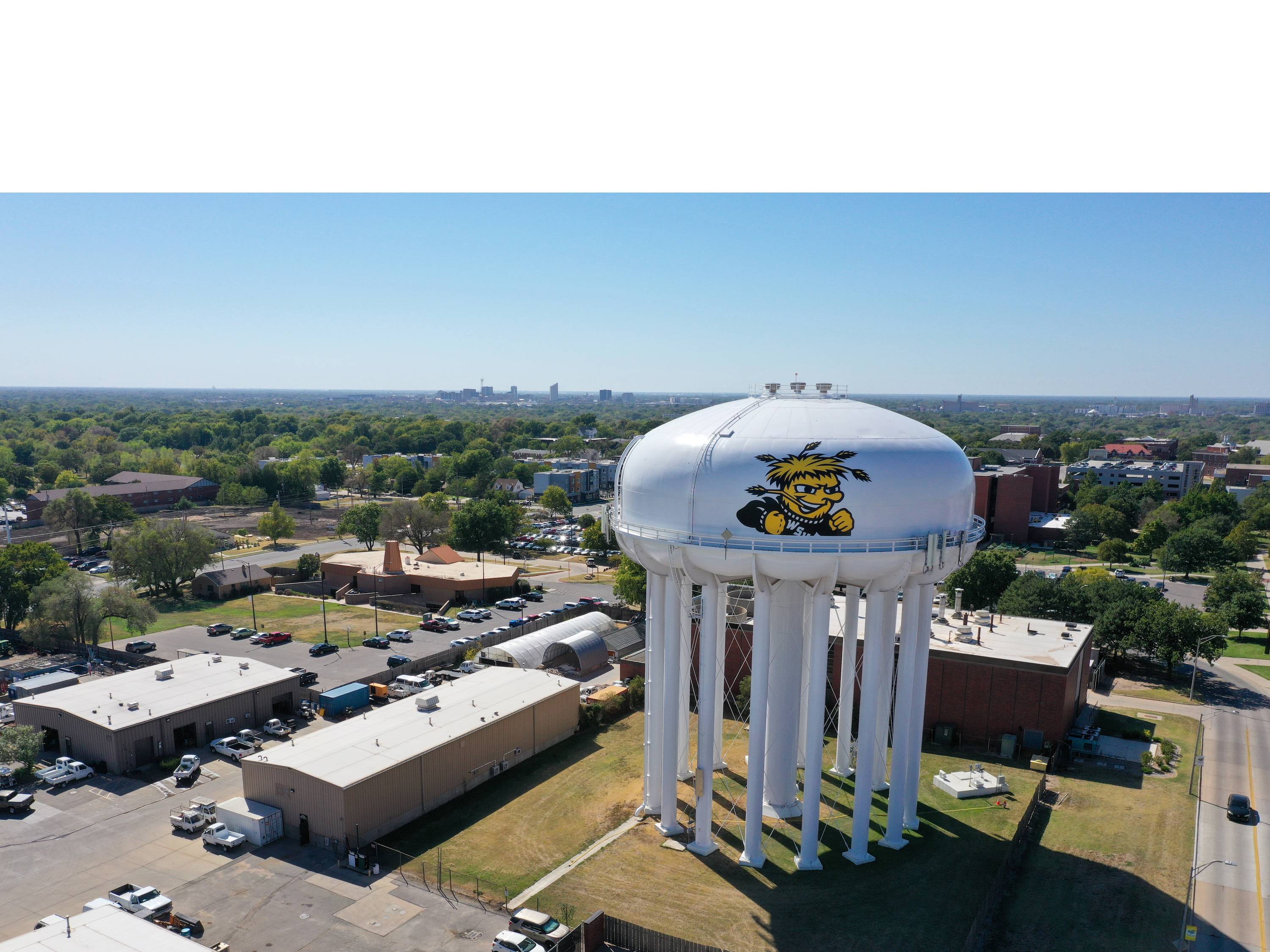 Aerial drone photo of campus during the daytime with the water tower in the foreground. 