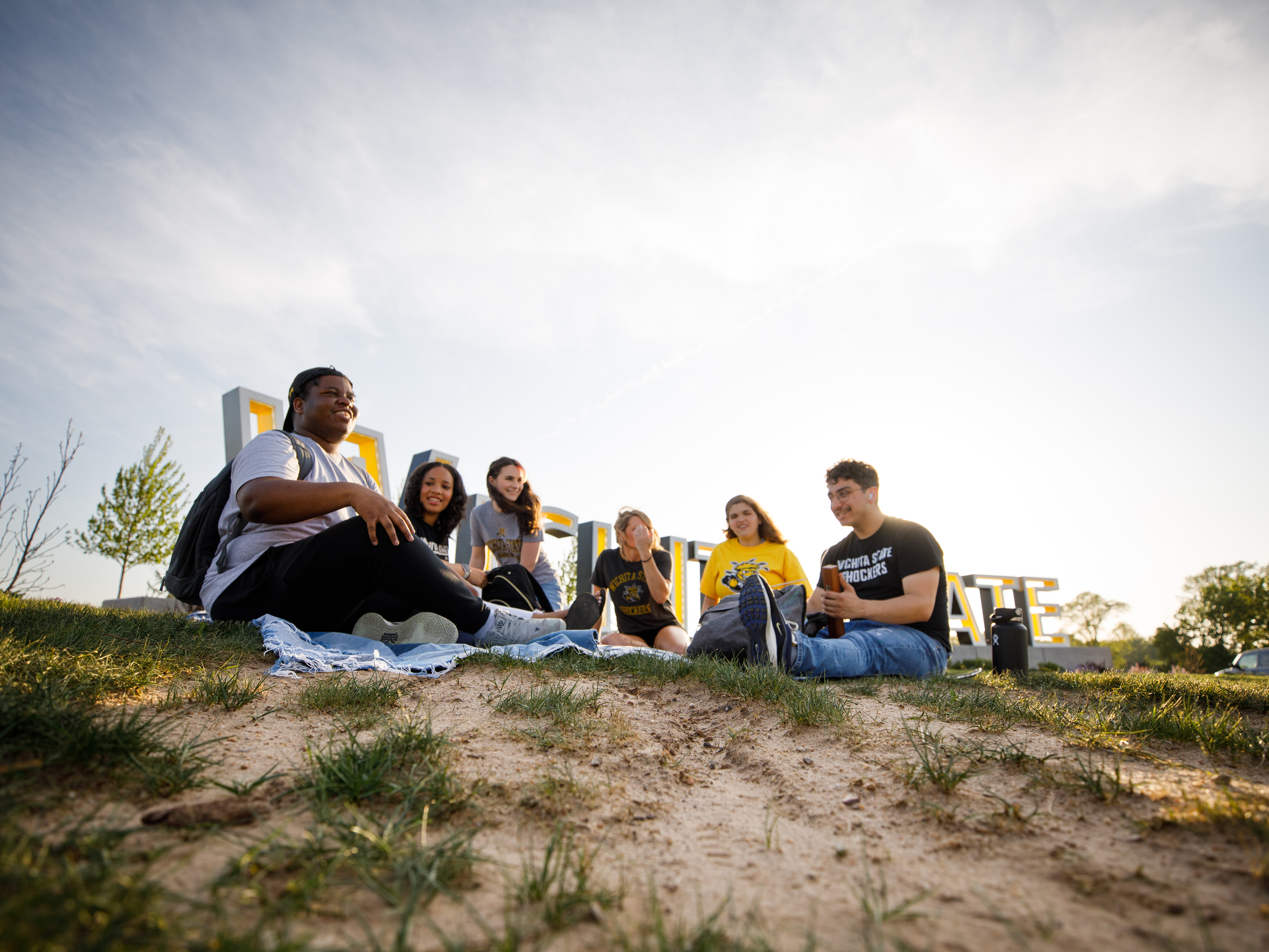 WSU students in front of the new Wichita State sign