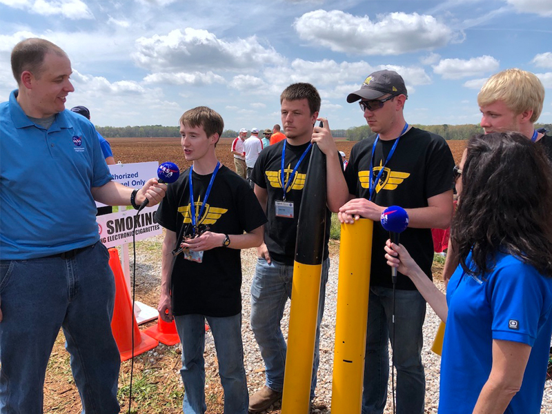 The WSU SLI team from left to right, Bryan Cline, Skylar Dean, Jonathan Bowerman, Mike Foster interview with NASA correspondents after their rocket launch. The team reported that the rocket performed according to expectations.