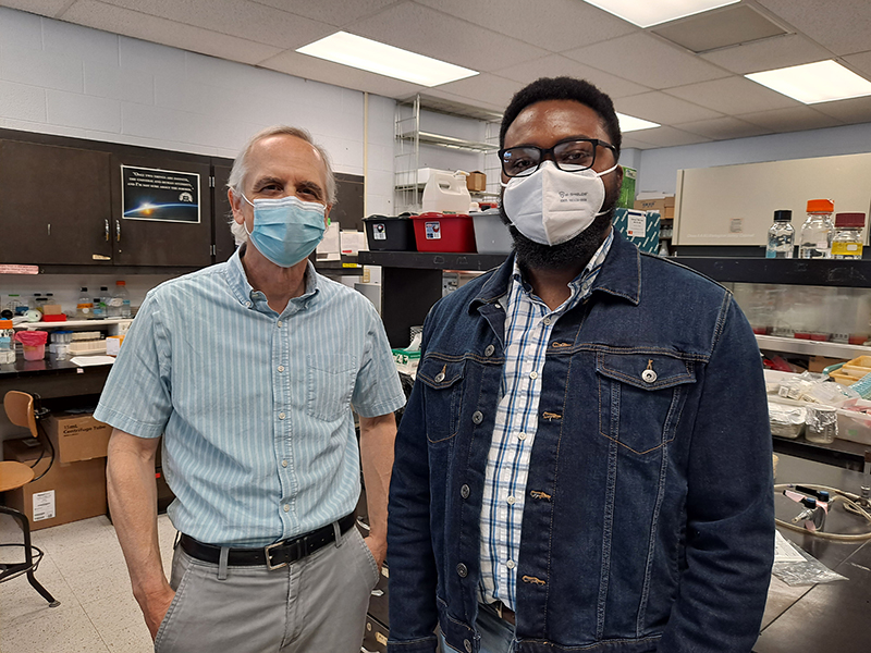 Mark Schneegurt and Egbo Munonyedi pose for a photo after a Sigma Xi initiation ceremony.