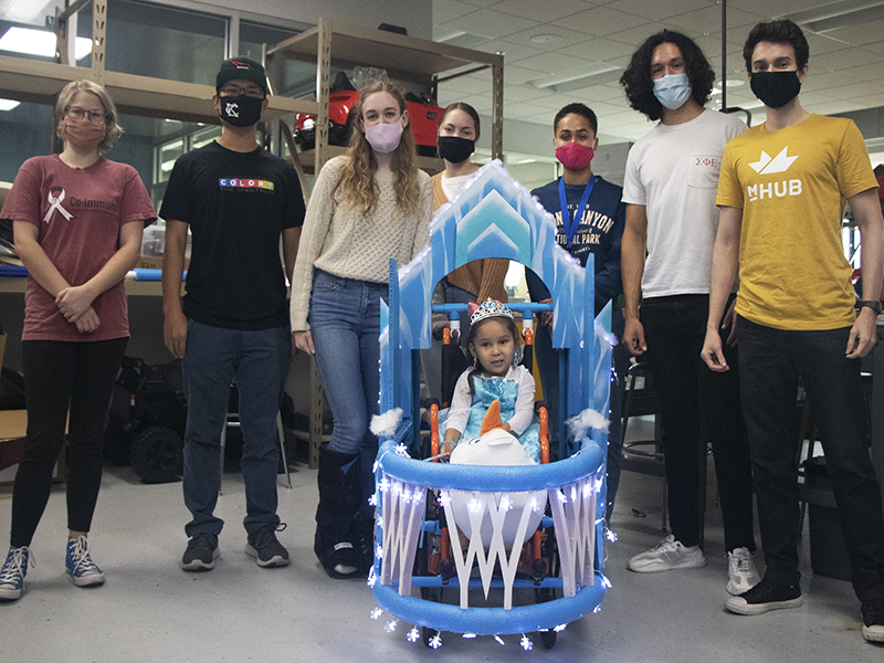 WSU engineering students pose with child Rockin' & Wheelin costume.