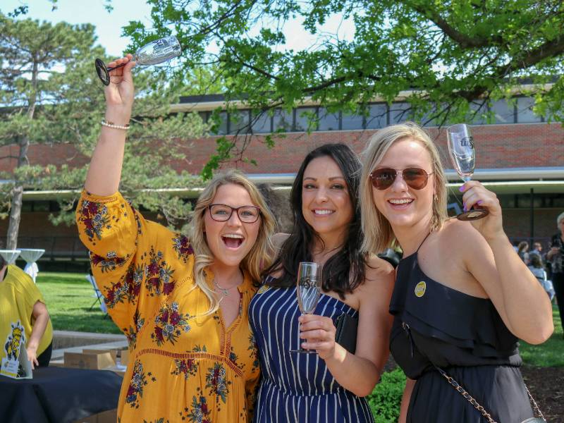 Graduates toasting with champagne classes