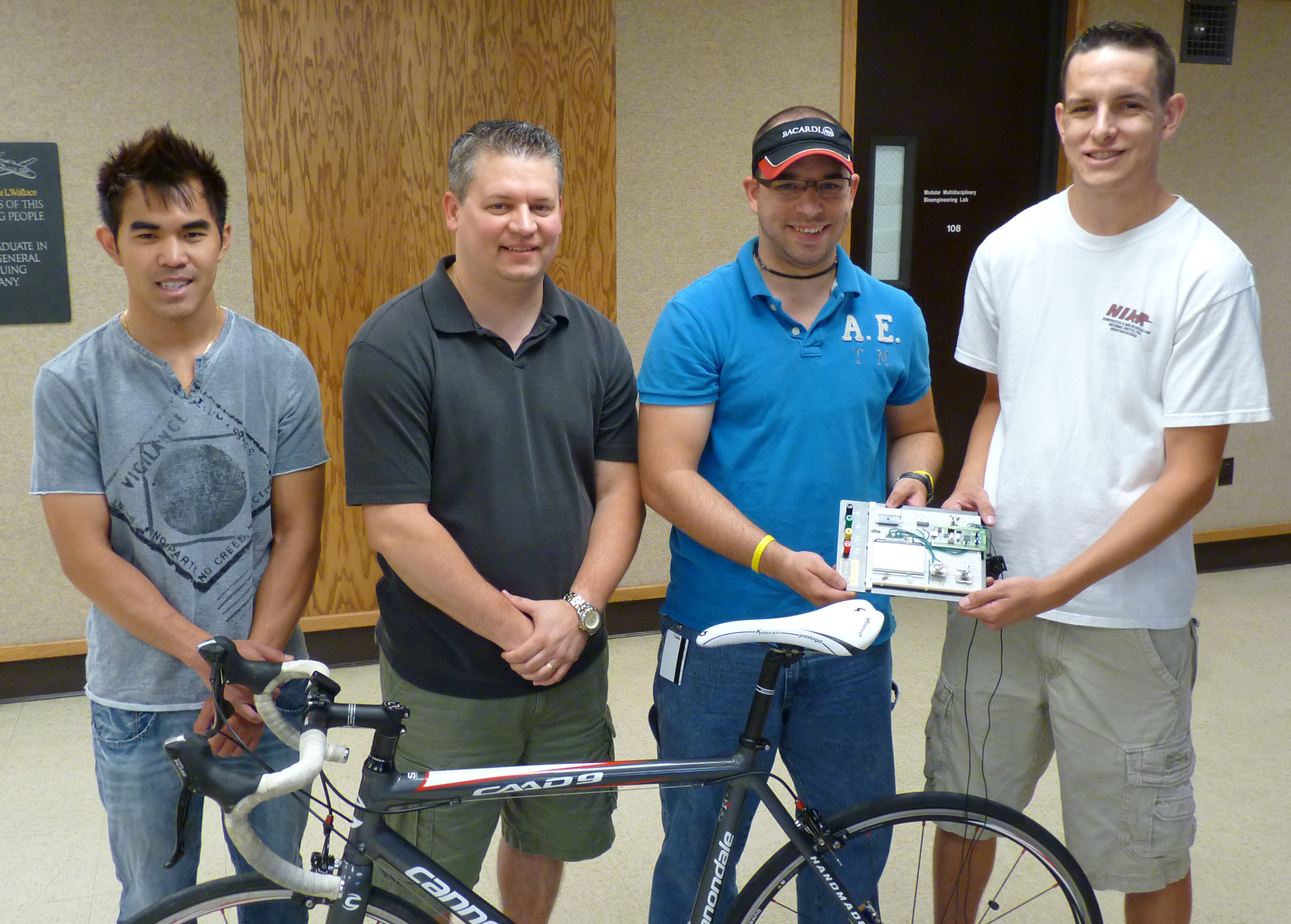 From left: Thuan Nguyen, Alex Esparza, Joe Christman and A.J. Whitaker with their new invention, the Xi Sport-Cyclist Training Device.