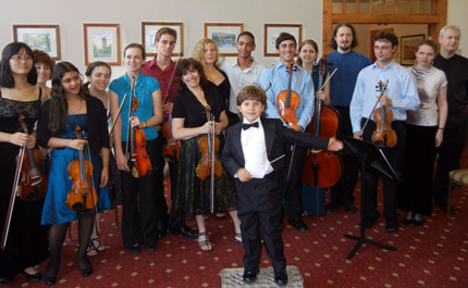 Jonathan Okseniuk, a 5-year-old conductor and violinist, will perform with the St. Petersburg String Quartet and its new chamber group, Supima Orchestra, in a benefit concert for the St. Petersburg International Music Academy at 7:30 p.m. Tuesday, Nov. 22. Pictured are Okseniuk, center front; and two of the four quartet members, Alla Aranovskaya, seventh from the left, and Boris Vaynor, fourth from the right.