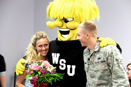 With help for Wichita State University's mascot WuShock, Senior Airman Brett Combs, on leave from Afghanistan, surprised his wife, WSU student Estefany Tabb, with a bouquet of flowers in her classroom at Ahlberg Hall.