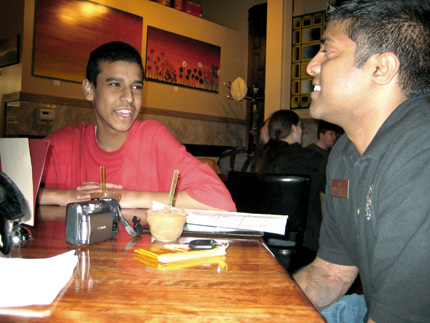 Hussam Aly, a student from Olathe Northwest, talks with WSU's Bobby Gandu during a trip to Wichita.