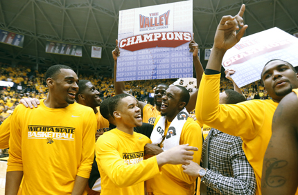 Shocker men's basketball players celebrate their 2014 Missouri Valley Conference Regular Season Championship following a victory over Drake Saturday night.