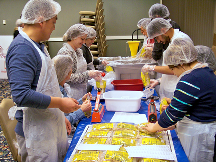 Volunteers from Wichita State and other institutions gathered at the Hyatt Regency Wichita to assemble dinners for donation to the Kansas Food Bank. The groups packaged more than 5,000 meals.