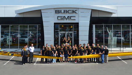 Shocker rowers pose with two new racing shells at a dedication ceremony Monday, May 19, at Donovan Auto and Truck Centerâ€™s main dealership at 5800 W. Kellogg.