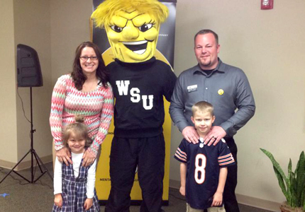 Jeremiah Raymo and his family, posed with Wu Shock, for the 30th anniversary open house of CCSR.