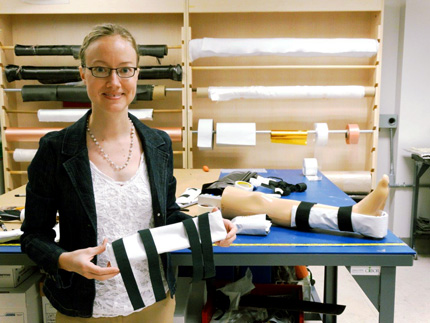 Kim Reuter shows off the fast-setting splint developed at WSU for the Department of Defense.