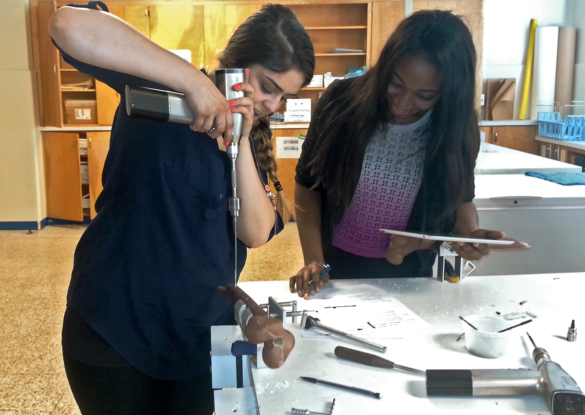 Two students work on composite hip bone in Biomechanics, a required course for the bachelor's degree in biomedical engineering. More than half of students in the biomedical engineering program are women.