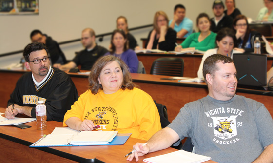 From left: Osher Scholars Charlie Dresie, Dotti Santiago and Brandon Casey listen to a lecture in their business management class last spring. All three graduated this year with bachelor's degrees in business administration.