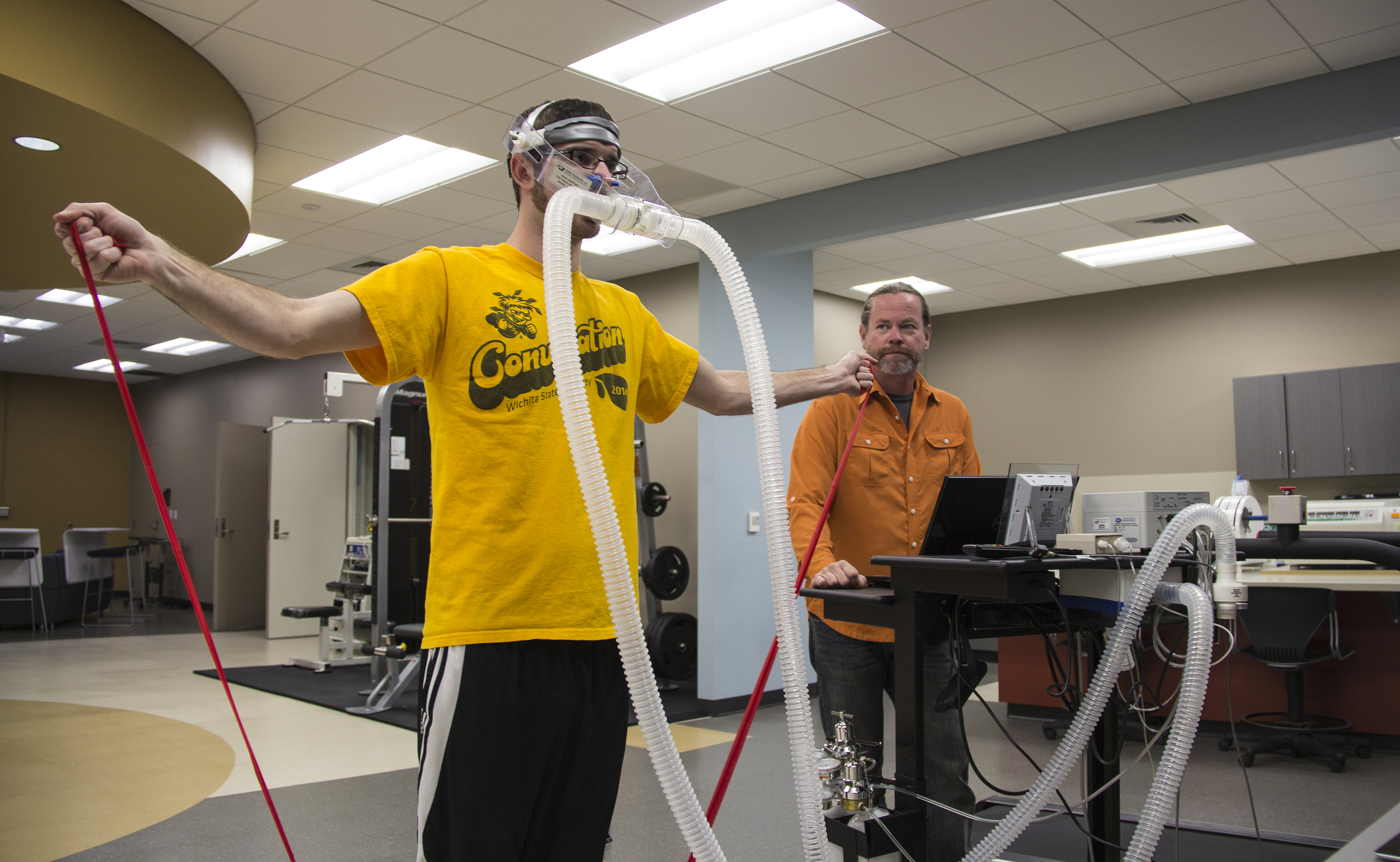 Michael Rogers, right, works with WSU student Kyle Waits on exercise band research.