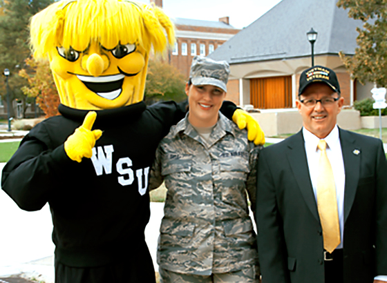 Master Sergeant Sarah Sell, a specialist in the Office for Student Success who oversees WSU's Military and Veterans Student Center, and Jim Pulliam, a Vietnam War vet and Chief Information Officer, pose with WuShock. The university's new Veterans Preference program is designed to attract more veterans to work for the university.