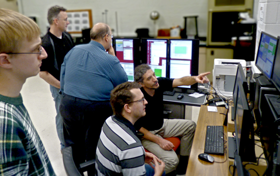 WSU physics professors and students watch data stream in to a new NOvA experiment control center in the basement of Jabara Hall. From left: WSU student Conner Ubert, Information System Specialist Mark Arrasmith, Professor Nick Solomey, Assistant Professor Mathew Muether and Associate Professor Holger Meyer.