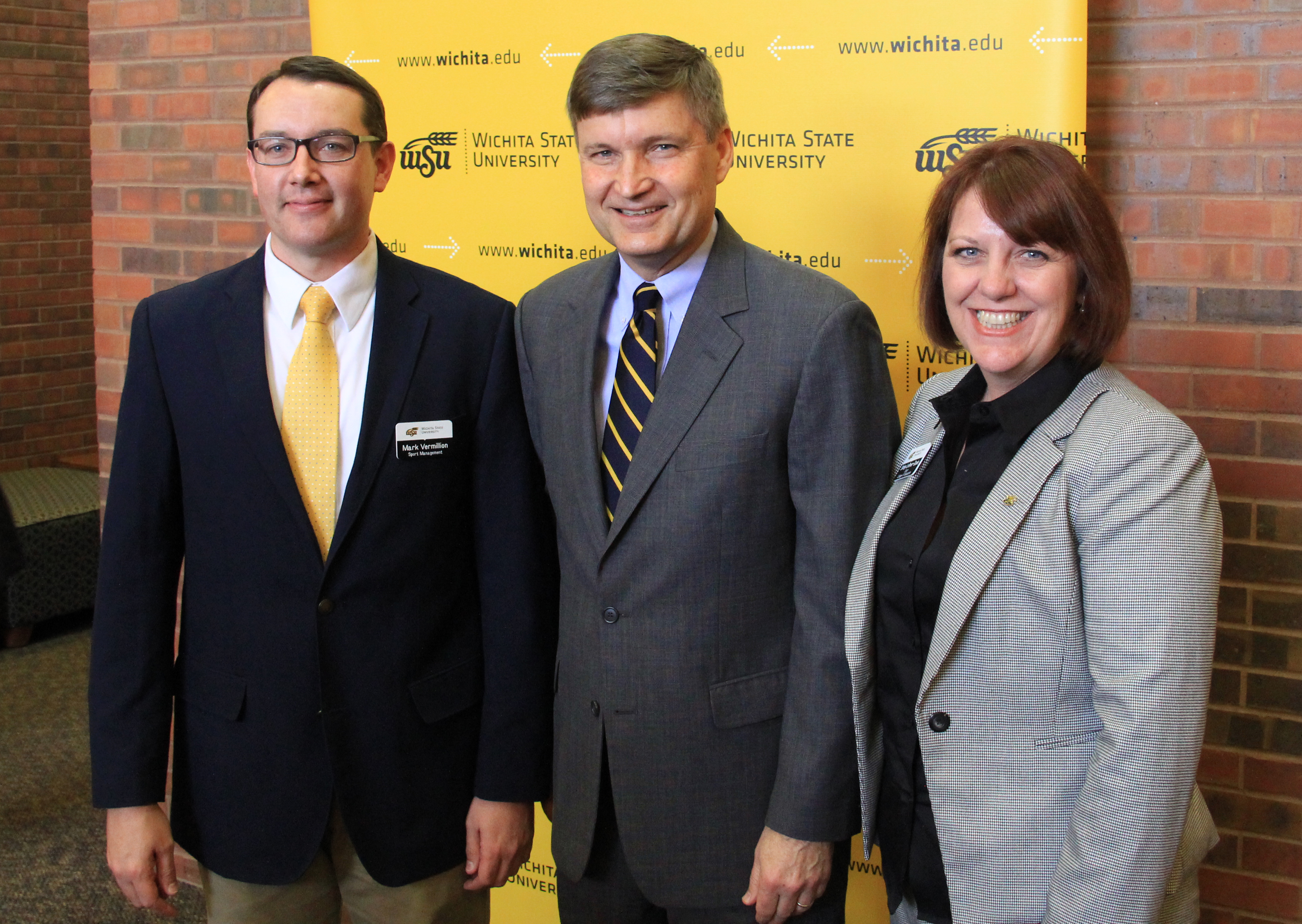 Kevin Weiberg, center, poses with WSU College of Education Dean Shirley Lefever-Davis and Mark Vermillion, chairperson and associate professor in WSU's sport management department. Weiberg, who once served as commissioner of the Big 12 Conference, will join the sport management department as executive-in-residence.