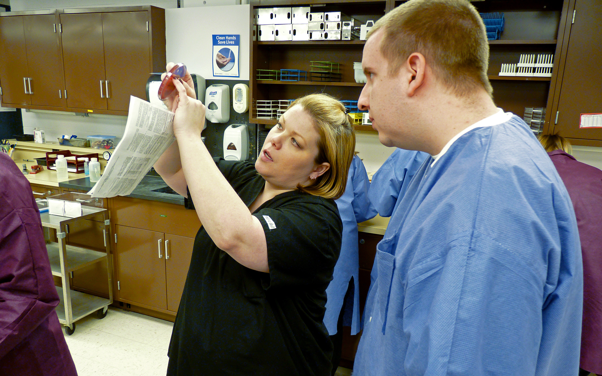 Clinical Educator Stephanie Rogers instructs a student in a microbiology class at Ahlberg Hall. WSU's Medical Laboratory Sciences program boasts a 100 percent placement rate after graduation.