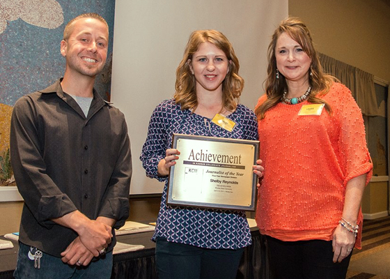 Jostens representative Travis Feil, left, and KCM President Laura York Guy recognized WSU journalism student Shelby Reynolds, center, as journalist of the year.