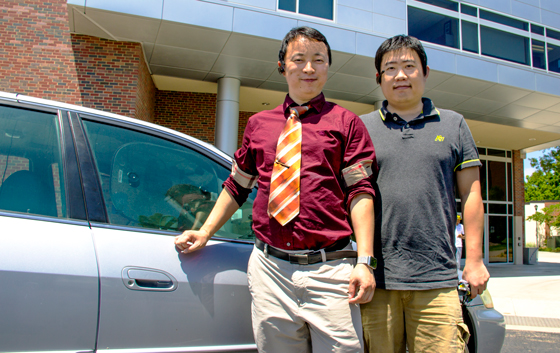 Wichita State professor Jibo He, left, and grad student Long Wang have collaborated with Vigo Technologies Inc. to create a headset that detects and alert drowsy drivers.