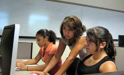 Roni Ayalla, center, the camp's Web production instructor, assists two students in producing an online news source to showcase the campers' work.