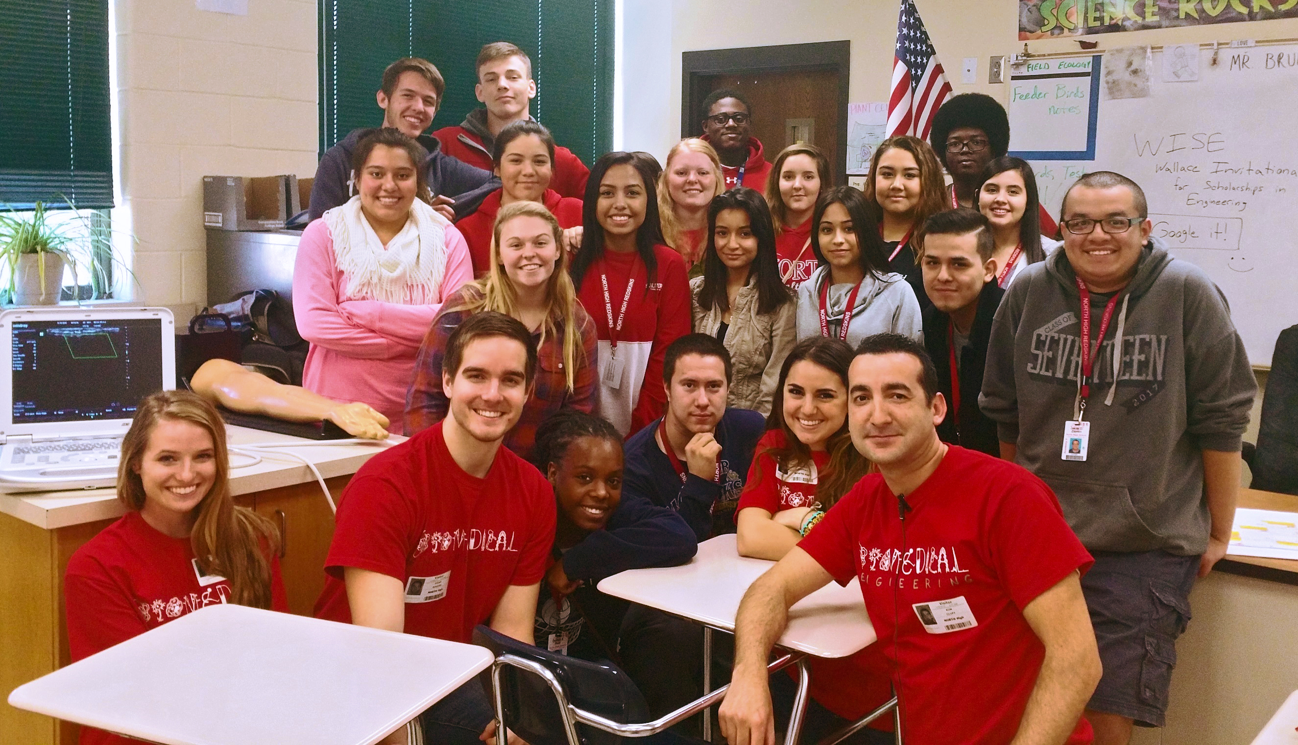 Kim Cluff is a first-generation minority college graduate who's using his experiences and knowledge to help students at Wichita's North High School., Kim Cluff, foreground, and Wichita State students meet with North High students as part of a new mentoring program in biomedical engineering.