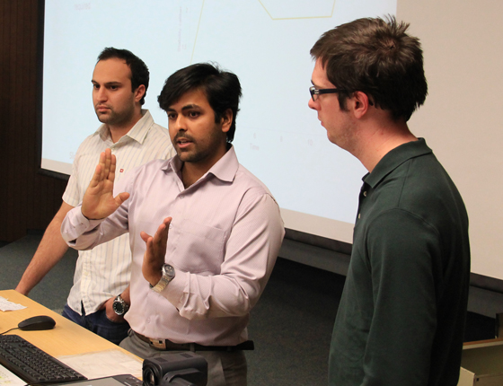 Aeronautical engineering student Tarun Bali answers a question from WSU professor Scott Miller following his team's senior presentation. Teammates include Kurush Tavadia, left, and Jacob Hart-Lane, right.