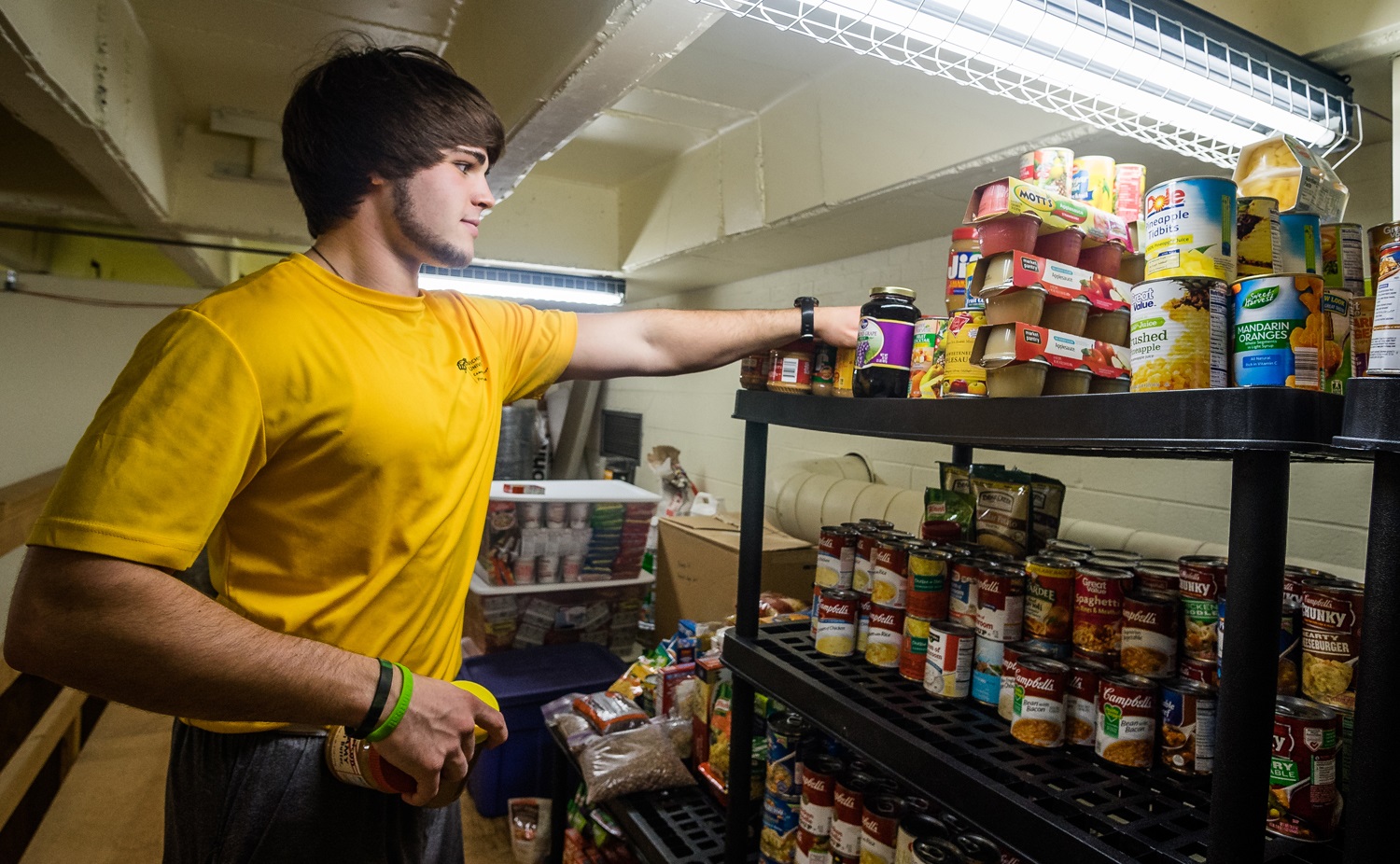 Sophomore Joey Oste organizes items for Wichita State's new food pantry for students who struggle with food insecurity.