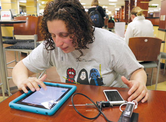 Senior Emily Schlenker, a blind pre-medical student, demonstrates how her new digital caliper takes measurements for her and sends them to an audio program on her iPad.