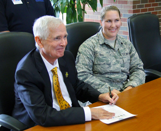 WSU President John Bardo signs a statement of support for the Employer Support of the Guard and Reserve (ESGR) on Thursday as Sarah Sell, WSU's director of Veteran Student Services, looks on.