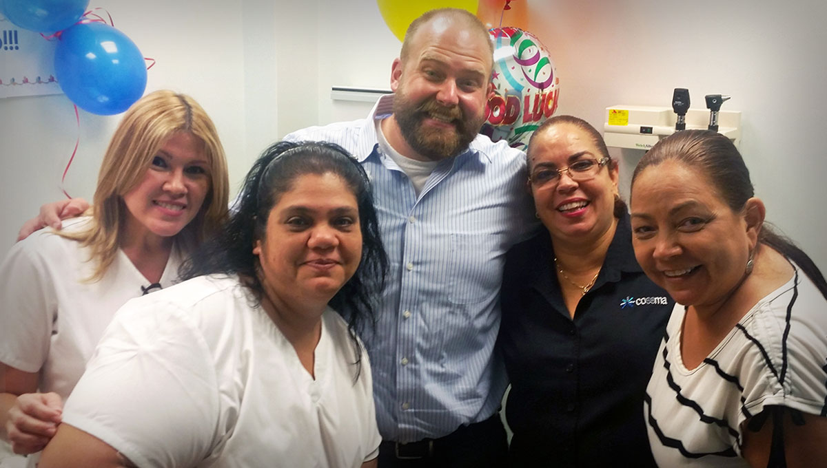 Troy Richardson (center) with staff members at the COSSMA clinic in Puerto Rico.