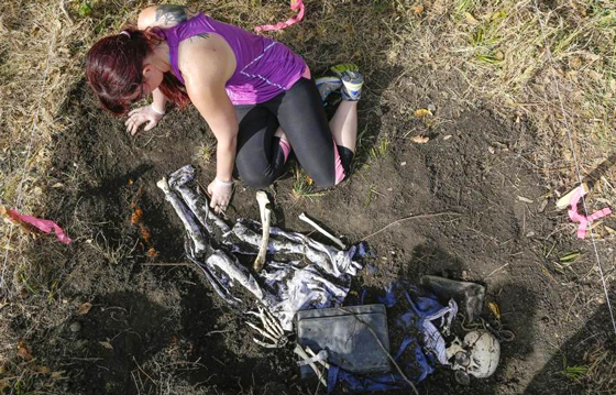 Wichita State anthropology graduate student C.J. Barringer digs up the remains of a skeleton at the school's Skeleton Acres research station in Butler County. Anthropology professor Peer Moore-Jansen has students dig up mock murder victims buried weeks ago.