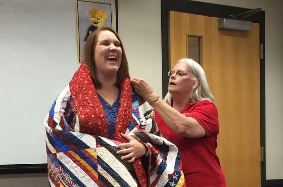 First-Year Seminar class, Cross Cultural Communication, awarded a Quilt of Valor to Sarah Sell, director of Veteran Student Services.