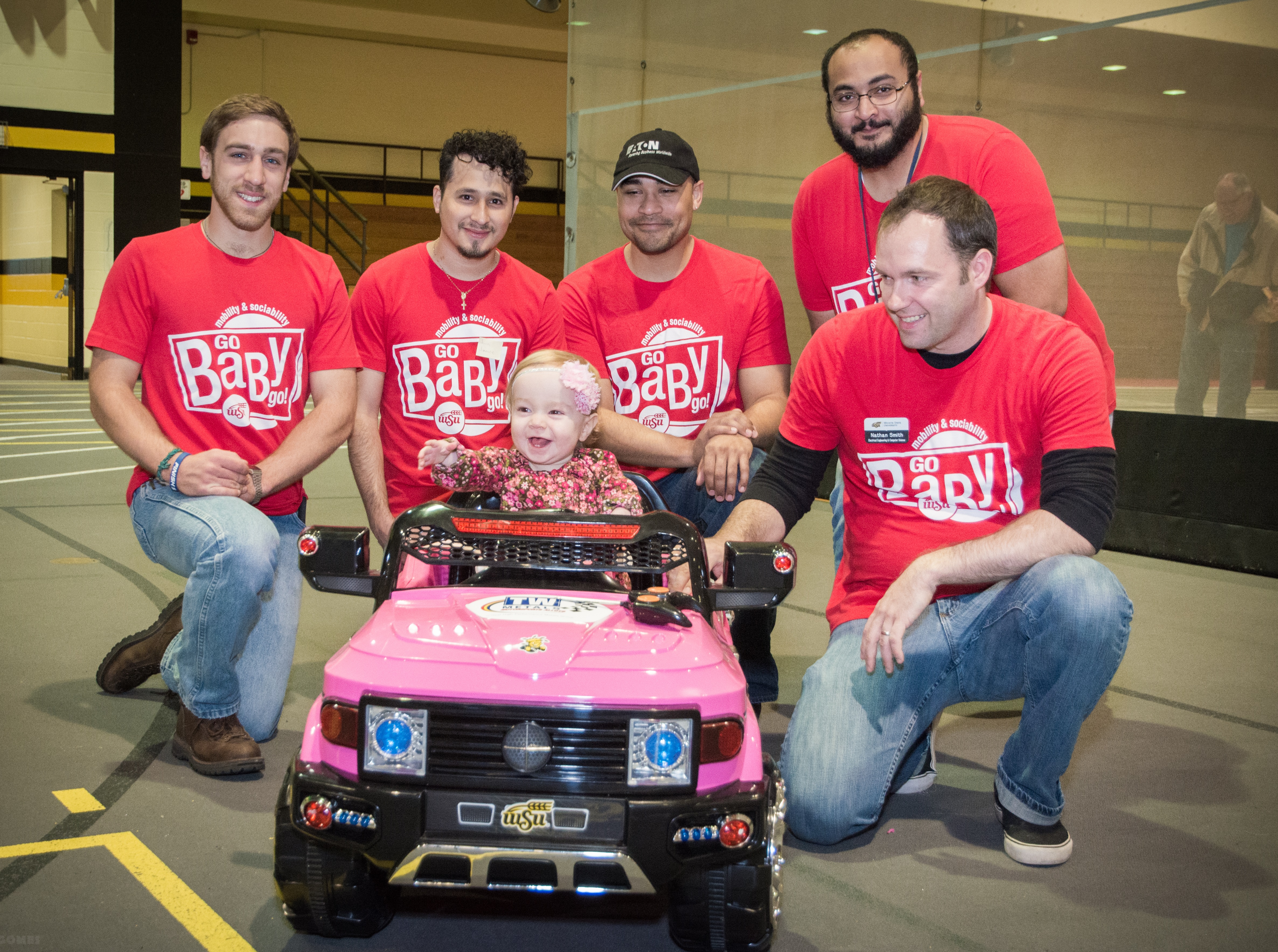 GoBabyGo students present Zoey with her modified car, controlled by an Andruino-powered joystick.