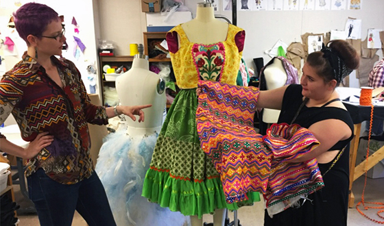 Wichita State theater intern Payton Dickerson, right, and her designer Genevieve V. Beller decide on what type of fabric to use for a belt.