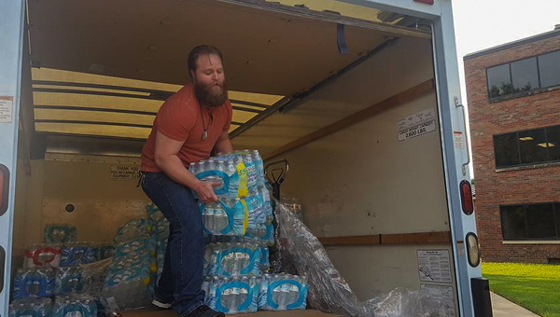 Last fall, the Student Veterans Organization collected supplies for victims of Hurricane Harvey. Marine Michael Bearth helped unload three pallets of water bottles to send to Houston.