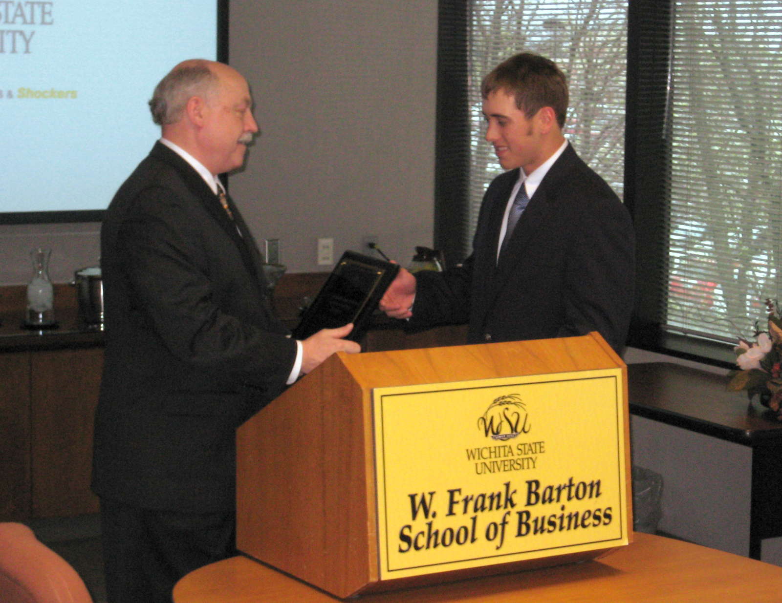 Doug Hensler, dean of WSU's Barton School, congratulates Clint Schulte, one of the recipients of the 2009 Jabara Scholarship in Entrepreneurship.