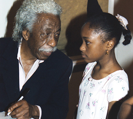 Gordon Parks and an unidentified girl in the late 1990s at a showing of Parks' work at the Ulrich Museum on the WSU campus.