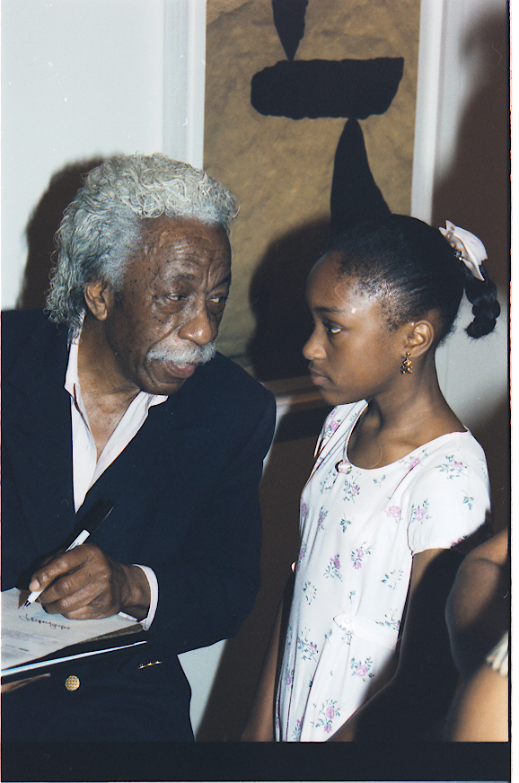 Gordon Parks and an unidentified girl in the late 1990s at a showing of Parks' work at the Ulrich Museum on the WSU campus.