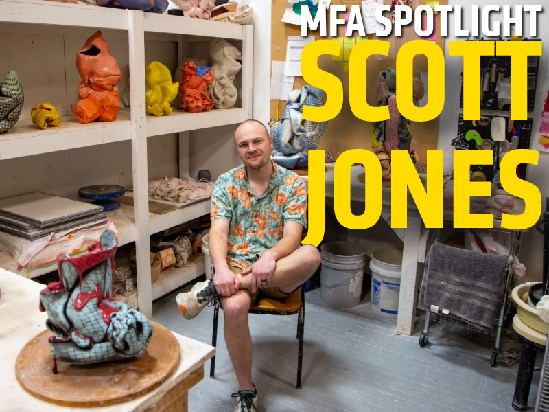 MFA student Scott Jones sits in a chair in his Henrion Hall studio surrounded by art supplies and multicolored ceramic sculptures.