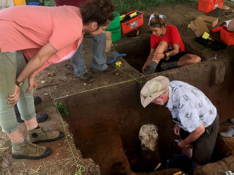 WSU professor and student team at dig site